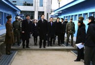 In this photo released by South Korean Unification Ministry, head of South Korean working-level delegation Lee Duk-haeng, center, prepares to cross a border line to hold a meeting with North Korea at Tongilgak in the North Korean side of Panmunjom which has separated the two Koreas since the Korean War, Wednesday, Feb. 5, 2014. Red Cross delegates from the rival Koreas begun talks Wednesday on holding reunions of families separated since the Korean War ended in the early 1950s. (AP Photo/South Korean Unification Ministry)