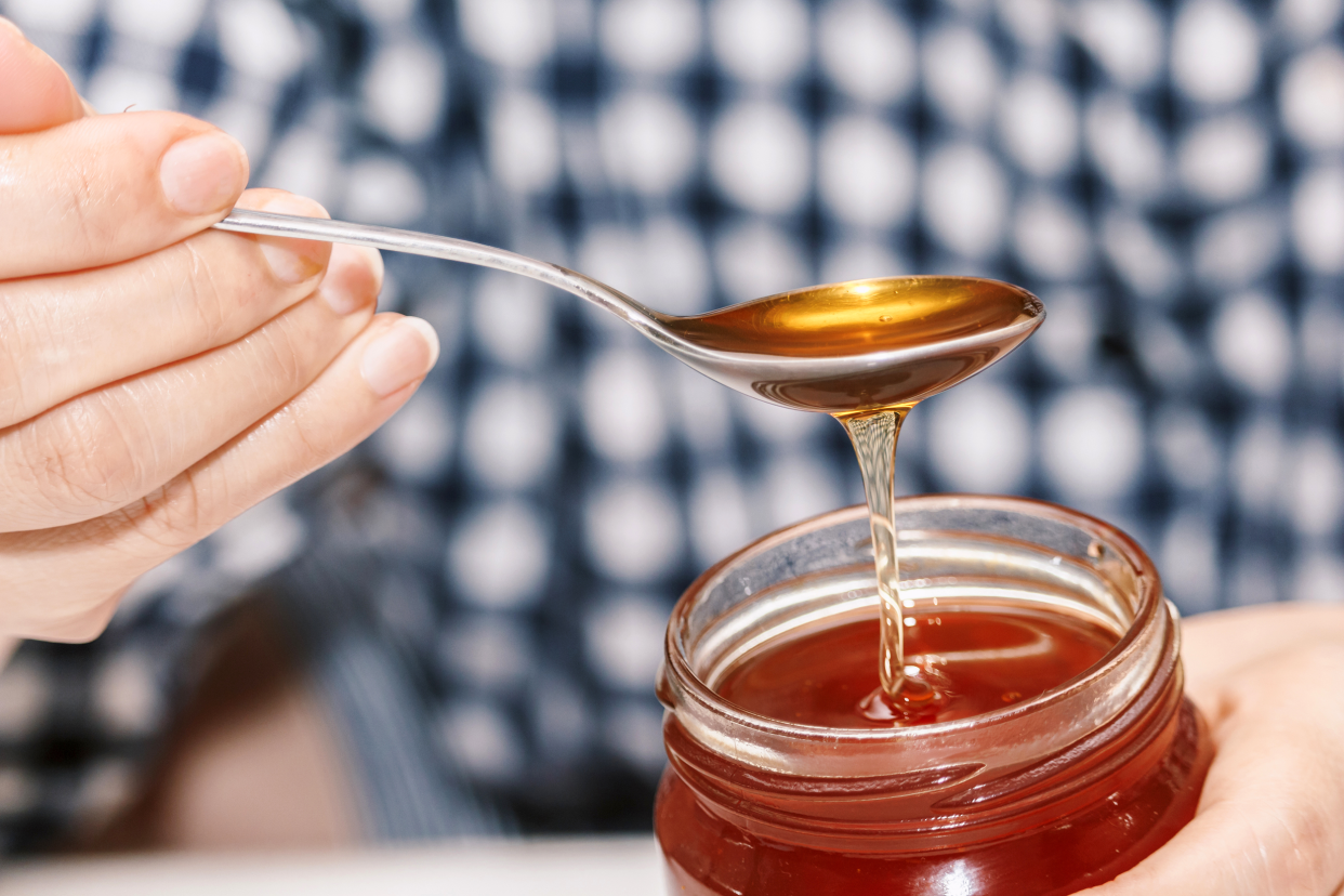 Spoonful of honey from a jar
