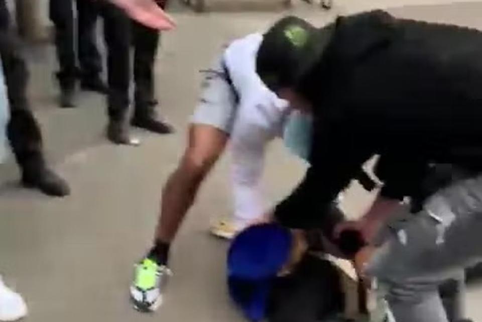 The man is attended to by others after being knocked to the ground (Twitter)