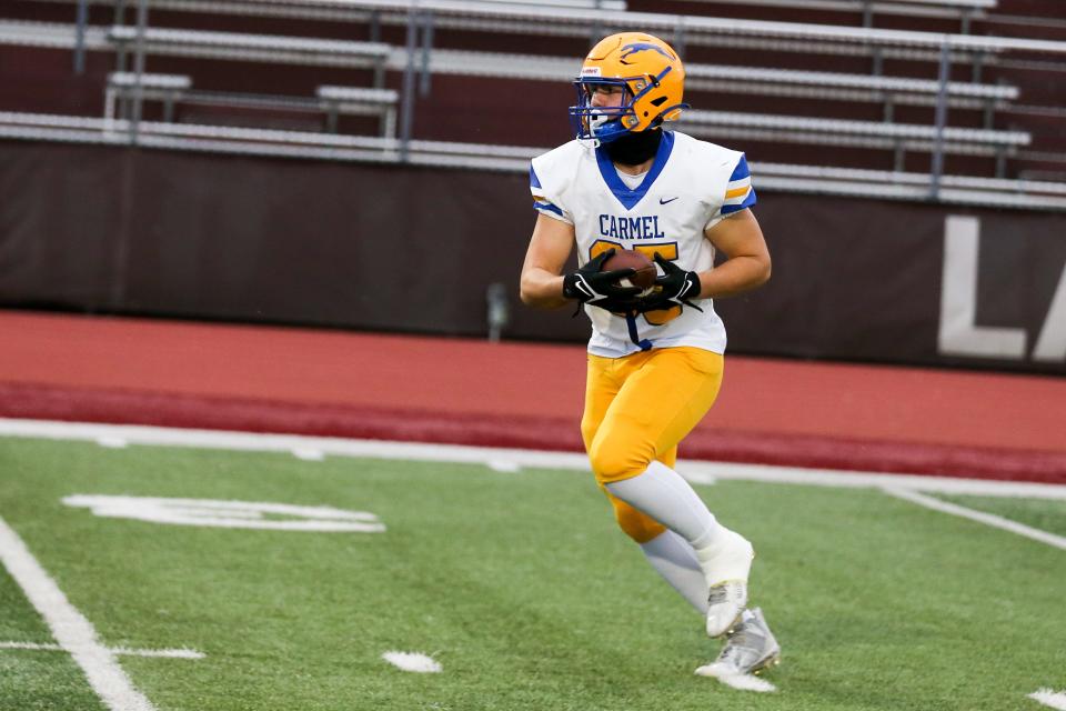 Carmel's Ozzy Pollard (85) warms up before the game during Lawrence Central vs Carmel IHSAA high school football, Oct 13, 2023; Indianapolis, IN, USA; at Lawrence Central High School.