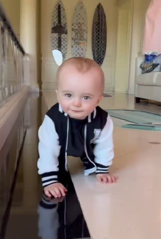 <p>Paris Hilton/TikTok</p> Phoenix Barron crawling and smiling