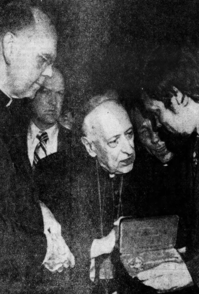 Jozsef Cardinal Mindszenty accepts key to New York City at Kennedy Airport from Deputy Mayor Edward Hamilton, right, with Terence Cardinal Cooke, archbishop of New York, on hand to greet the prelate on his arrival.