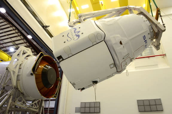 A SpaceX robotic Dragon space capsule is mated to the top of its Falcon 9 rocket ahead of a planned March 2014 launch to the International Space Station from Cape Canaveral Air Force Station, Florida. Image released March 11.