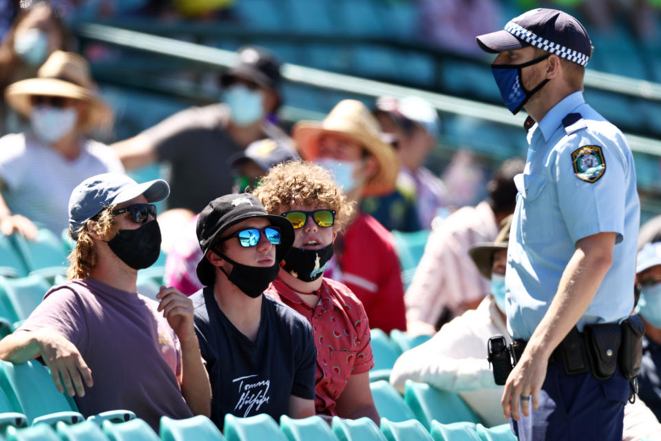 SYDNEY, AUSTRALIA - JANUARY 10: Police speak to spectators following a complaint from Mohammed Siraj of India that stopped play during day four of the Third Test match in the series between Australia and India at Sydney Cricket Ground on January 10, 2021 in Sydney, Australia. (Photo by Cameron Spencer/Getty Images)