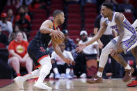 Houston Rockets guard Eric Gordon, left, attempts to drive past Sacramento Kings guard Malik Monk, right, during the first half of an NBA basketball game Monday, Feb. 6, 2023, in Houston. (AP Photo/Michael Wyke)