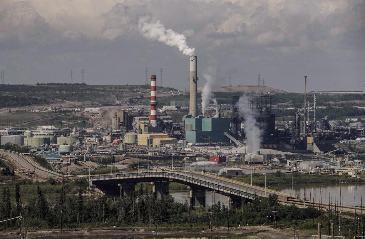 The Liberal government's framework to cap emissions from the oil and gas sector proposes to cap 2030 emissions at 35 to 38 per cent below 2019 levels in order to reach the government’s goal of reducing emissions in the sector to net zero by 2050. Suncor's plant in the oilsands in Fort McMurray, Alta, will fall under the framework.  (Jason Franson/The Canadian Press - image credit)