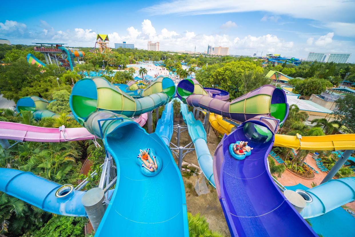 Guests slip and slide along Omaka Rocka at Aquatica Orlando.