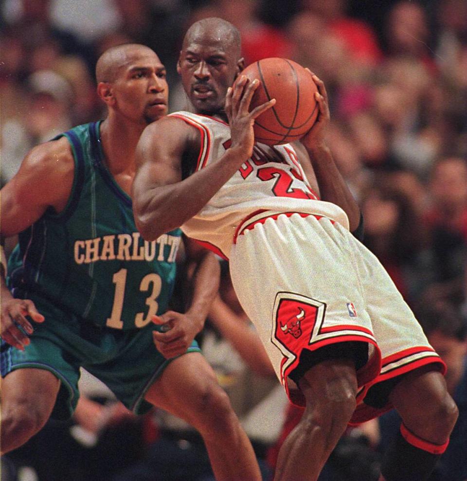 Charlotte’s Bobby Phills (13) guards future Hornets owner Michael Jordan in a 1998 playoff series between the Hornets and Bulls. Phills died in a high-speed car crash in 2000.