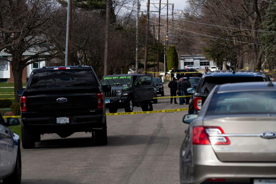 An officer brings out bags of evidence after a spree of violence claims four lives, injuring seven on Wednesday, March 27, 2024, near Cleveland Avenue in Rockford.
