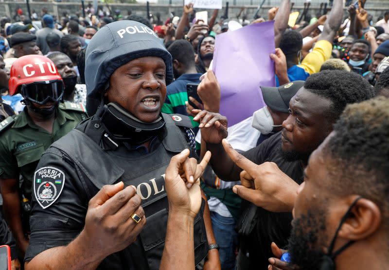 FILE PHOTO: Demonstrators talk to a police officer during a protest over alleged police brutality, in Lagos