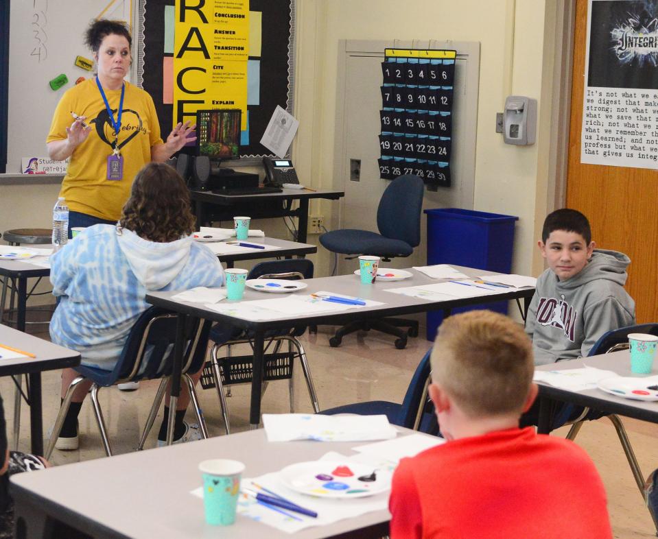 Lori Dehoff, a Sebring Local Schools intervention specialist, takes a vote on which picture a group of students want to paint after watching the movie "The Dolphins Tale" on Thursday, Aug. 17, 2023, at Sebring McKinley Jr./Sr. High School.