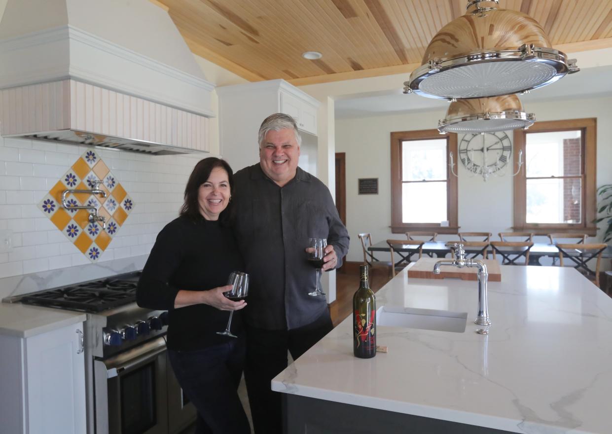 Prime Vine Winery owners Julie and Jim Pulk raise glasses in their remodeled mansion in New Franklin.