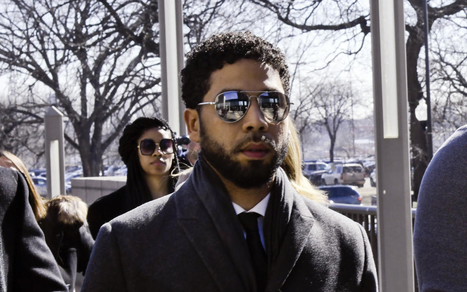 "Empire" actor Jussie Smollett, center, arrives at Leighton Criminal Court Building for a hearing to discuss whether cameras will be allowed in the courtroom during his disorderly conduct case on Tuesday, March 12, 2019, in Chicago. A grand jury indicted Smollett last week on 16 felony counts accusing him of lying to the police about being the victim of a racist and homophobic attack by two masked men in downtown Chicago.(AP Photo/Matt Marton)