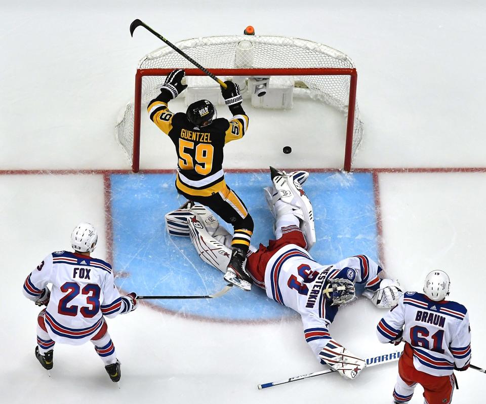 Pittsburgh Penguins left winger Jake Guentzel scores a goal against New York Rangers goaltender Igor Shesterkin in the second period of Game 4.