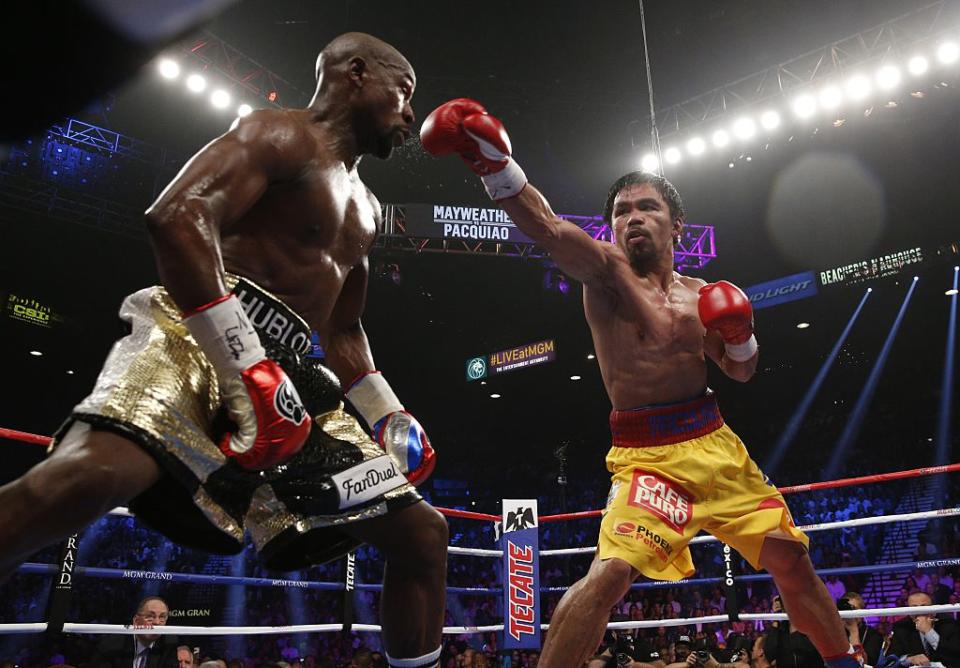 Floyd Mayweather Jr. exchanges punches with Manny Pacquiao during their welterweight unification championship bout on May 2, 2015 at the MGM Grand Garden Arena in Las Vegas, Nevada.<span class="copyright">John Gurzinski—AFP/Getty Images</span>