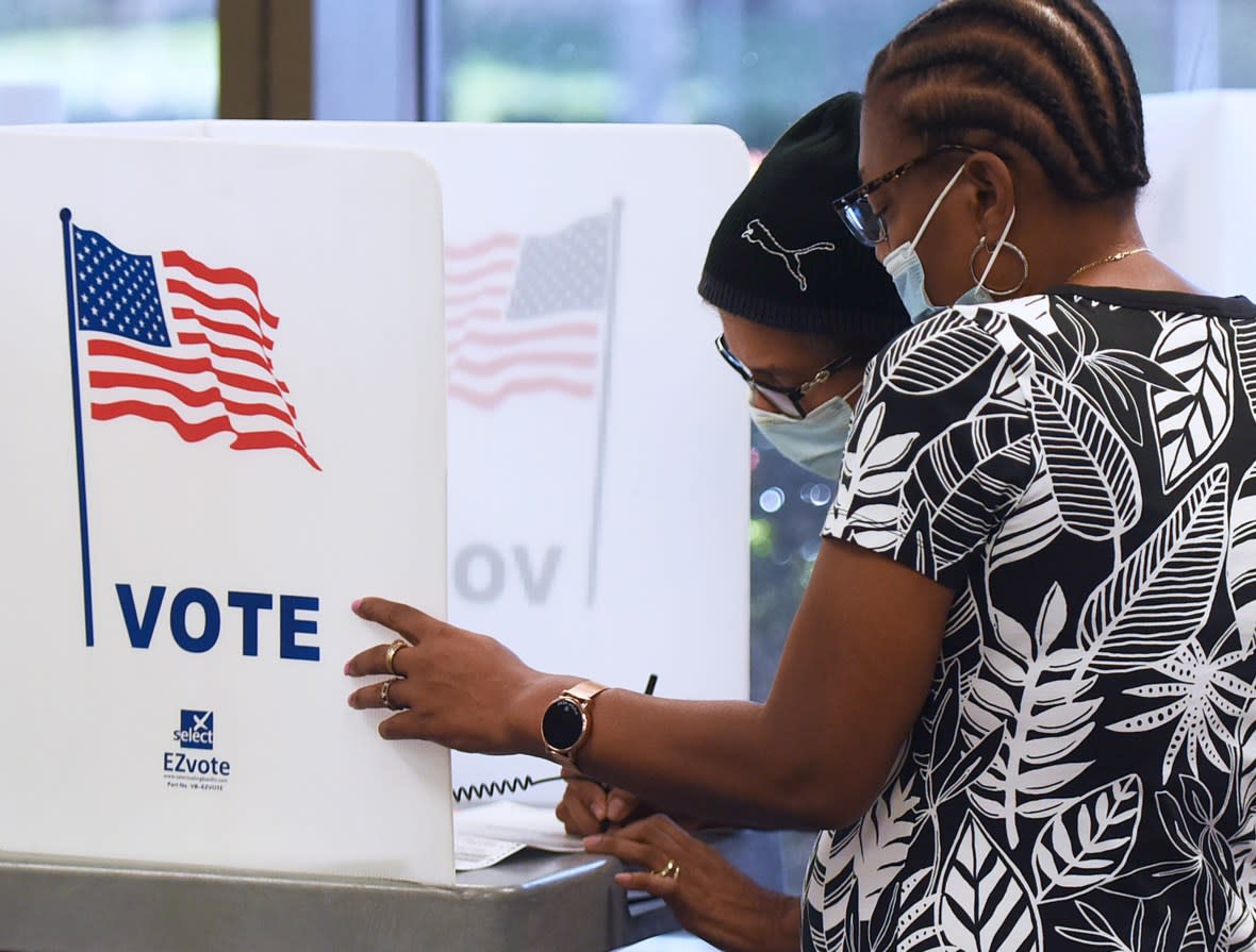 Women wearing face masks fill out vote-by-mail ballots at the Orange County Supervisor of Elections office on October 15, 2020 in Orlando, Florida. Florida voters have cast more than 2 million vote-by-mail ballots ahead of the November 3 election. (Photo by Paul Hennessy/NurPhoto via Getty Images)