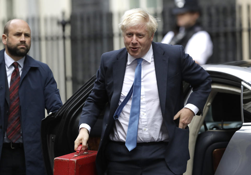 British Prime Minister Boris Johnson, center, arrives at Downing Street in London, Wednesday, Sept. 25, 2019. Lawmakers in Britain are returning to the House of Commons on Wednesday, following a Supreme Court ruling that Prime Minister Boris Johnson had acted illegally by suspending Parliament. (AP Photo/Matt Dunham)