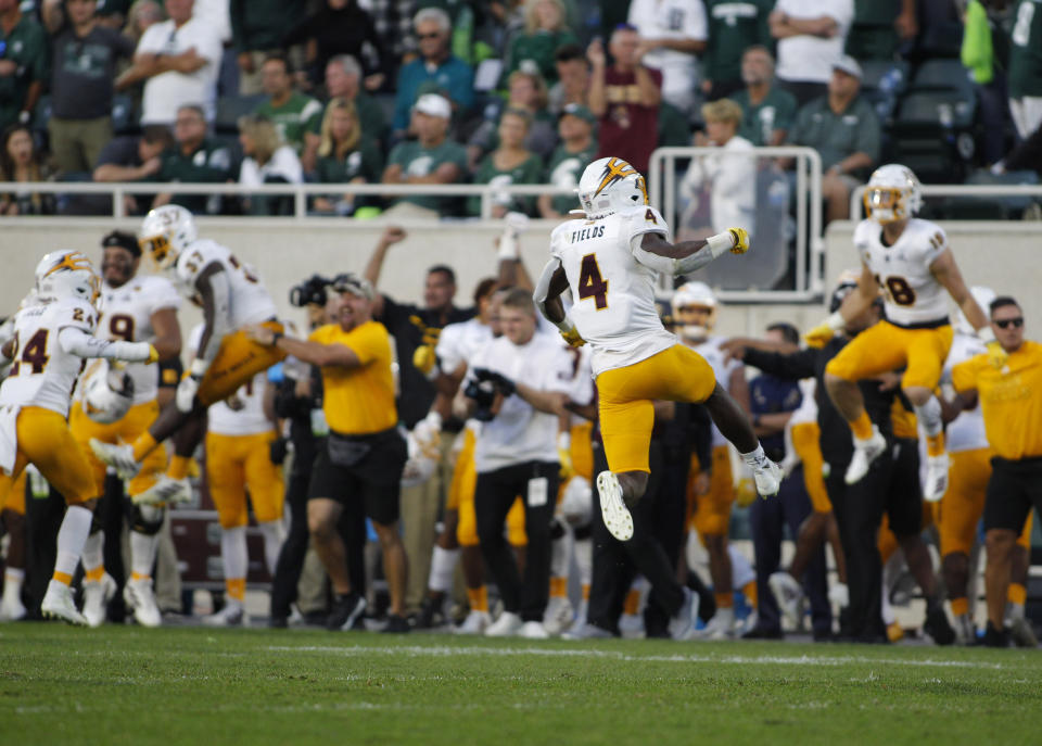 Arizona State players, including Evan Fields (4), celebrate at the conclusion of a win over Michigan State in an NCAA college football game, Saturday, Sept. 14, 2019, in East Lansing, Mich. (AP Photo/Al Goldis)