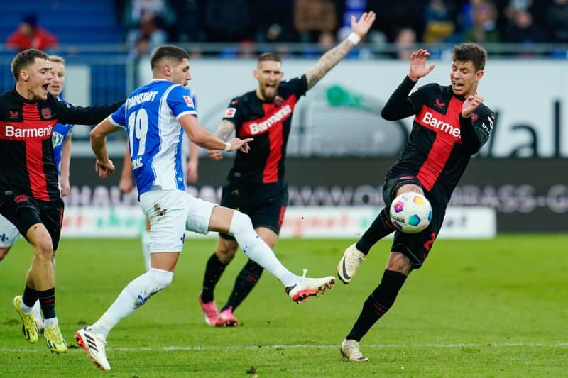 Darmstadt's Emir Karic (L) and Leverkusen's Adam Hlozek battle for the ball during the German Bundesliga soccer match between SV Darmstadt 98 and Bayer Leverkusen at the Merck-Stadion am Boellenfalltor. Uwe Anspach/dpa