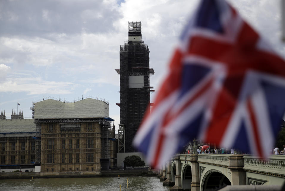 The Houses of Parliament are seem, with a Union Jack flag in the foreground, in central London, Wednesday, Aug. 28, 2019. British Prime Minister Boris Johnson asked Queen Elizabeth II on Wednesday to suspend Parliament, throwing down the gauntlet to his critics and causing outrage among opposition leaders who will have even less time to thwart a no-deal Brexit. (AP Photo/Matt Dunham)