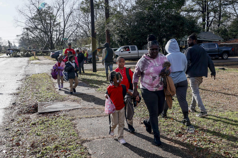 CORRECTS DAY OF WEEK TO THURSDAY, NOT WEDNESDAY - Children walk home from school after a tornado hit near Meadowview elementary school Thursday, Jan. 12, 2023 in Selma Ala.. (AP Photo/Butch Dill)