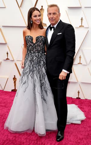 Kevin Mazur/WireImage Kevin Costner and Christine Baumgartner at the 94th Annual Academy Awards in 2022