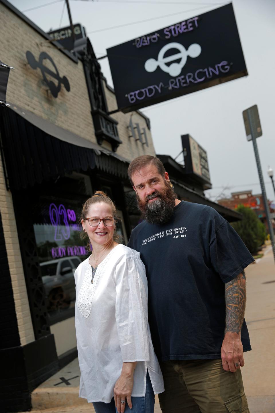 Jason and Tisha King, owners of 23rd Street Body Piercing and Atomic Lotus Tattoo, pose for a photo May 17 outside their shops in Oklahoma City.