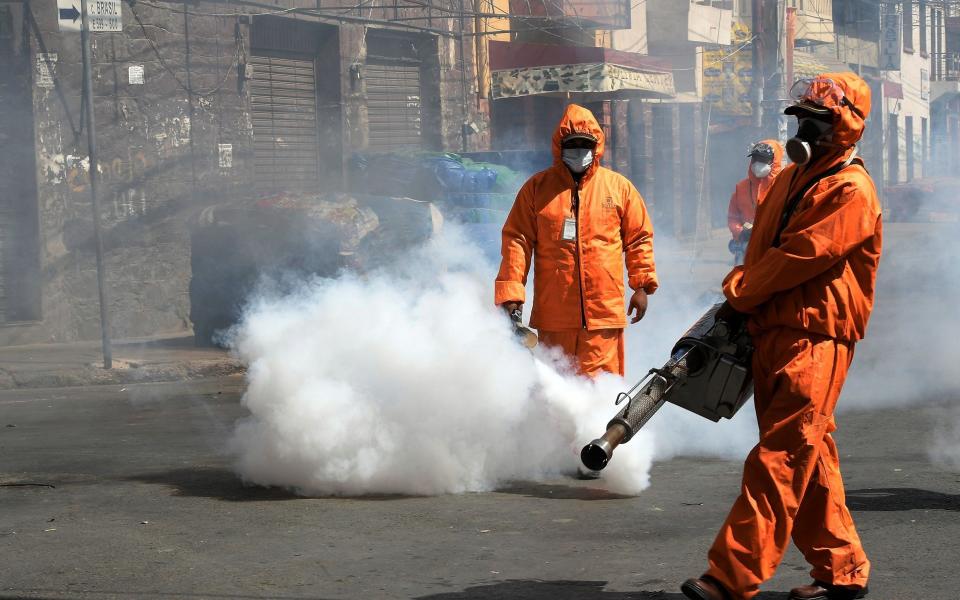  Municipal officials fumigate a street amid a stringent weekend quarantine in Cochabamba to try to halt a surge in infections - Jorge Ãbrego/EPA-EFE/Shutterstock 