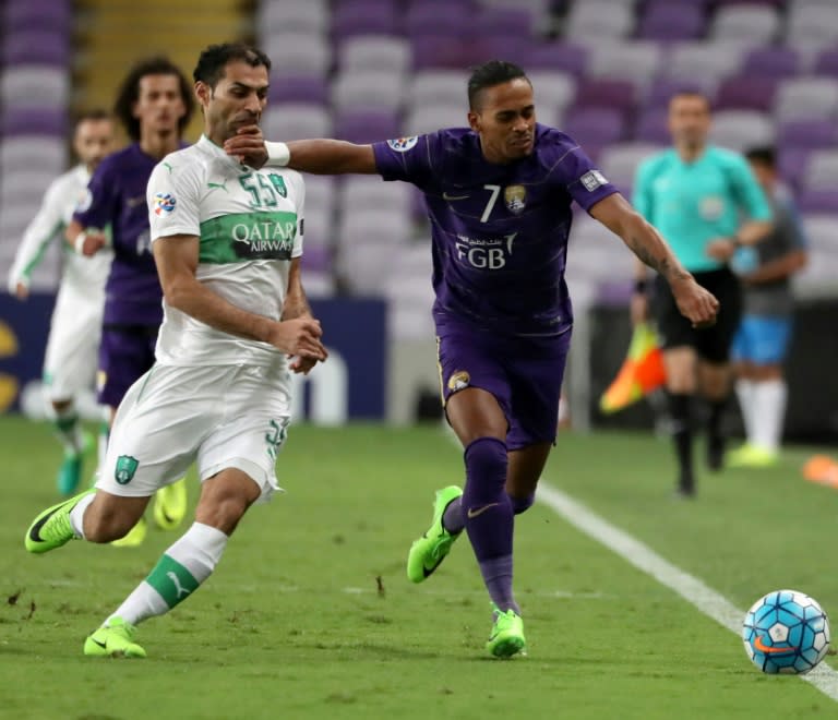 Al-Ain's midfielder Lucas Fernandes Caio (R) vies for the ball with Al-Ahli's midfielder Saad Abdul-Amir during their AFC Champions League Group C football match at the Hazza bin Zayed Stadium in Al-Ain on April 11, 2017