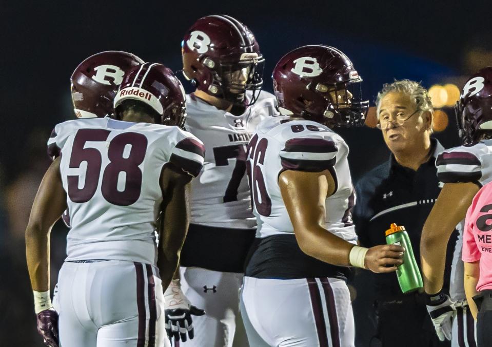 Bastrop Bears offensive line coach Kyle Spano, a former Lake Travis assistant coach, instructs offensive line players during a time out in the second quarter against the Cedar Creek Eagles at the District 13-5A football game on Friday, October 6, 2023, at Bastrop Memorial Stadium - Bastrop, Texas.