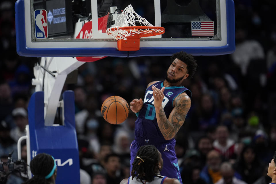 Charlotte Hornets forward Miles Bridges (0) dunks against the Detroit Pistons in the second half of an NBA basketball game in Detroit, Friday, Feb. 11, 2022. (AP Photo/Paul Sancya)