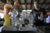 A waiter prepares cold refreshments at a beach bar of Lagonissi village, a few miles southwest of Athens, on Thursday, July 29, 2021. One of the most severe heat waves recorded since 1980s scorched southeast Europe on Thursday, sending residents flocking to the coast, public fountains and air-conditioned locations to find some relief, with temperatures rose above 40 C (104 F) in parts of Greece and across much of the region. (AP Photo/Yorgos Karahalis)