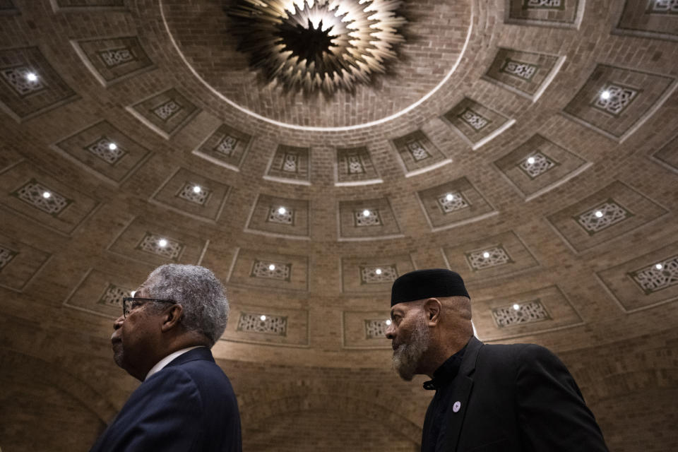 Rev. Dr. J. Wendell Mapson Jr., left, and Imam Kenneth Nuriddin exit following a public commemoration service for 19 unidentified Black Philadelphians whose remains were part of a display at the University of Pennsylvania's Penn Museum on Saturday, Feb. 3, 2024, in Philadelphia. As part of a growing effort among museums to reevaluate the curation of human remains, the Ivy League school laid some of the remains to rest last week. (AP Photo/Joe Lamberti)