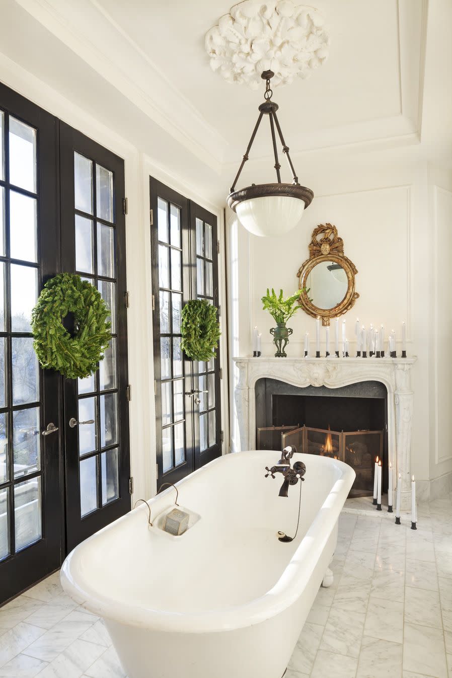 in designer darryl carters dc home the master bath has an antique claw foot tub and gilt mirror