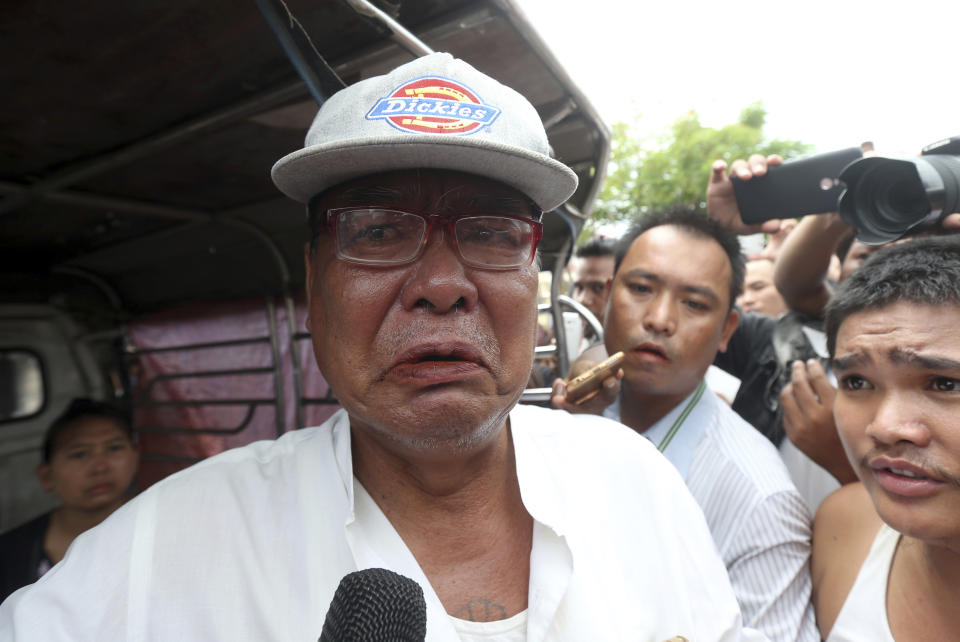 Mya Thein, father of rape suspect Aung Gyi, talks to journalists during the court appearance of his son Monday, July 15, 2019, in Nyapyitaw, Myanmar. A court in Myanmar has begun proceedings against a suspect in the rape of a 2-year-old girl at her nursery school that has generated huge public outcry. (AP Photo/Aung Shine Oo)