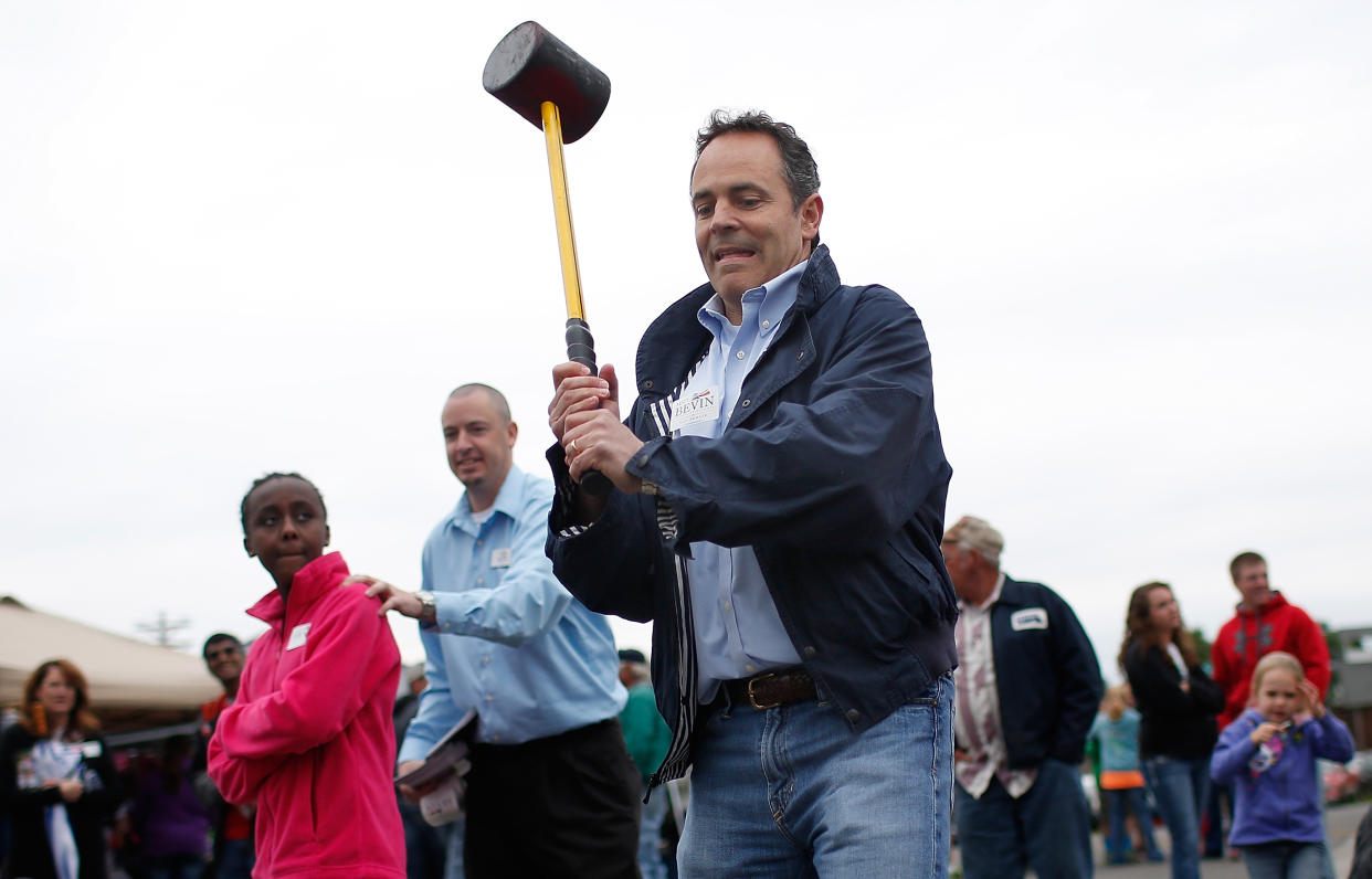 Kentucky Gov. Matt Bevin playing a “test your strength” game — not preparing for the zombie apocalypse. (Photo: Win McNamee/Getty Images)