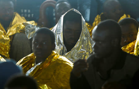 Migrants rest on the deck of Malta-based NGO Migrant Offshore Aid Station (MOAS) ship Phoenix after being rescued from a rubber dinghy in central Mediterranean on international waters some 15 nautical miles off the coast of Zawiya in Libya, April 14, 2017. REUTERS/Darrin Zammit Lupi