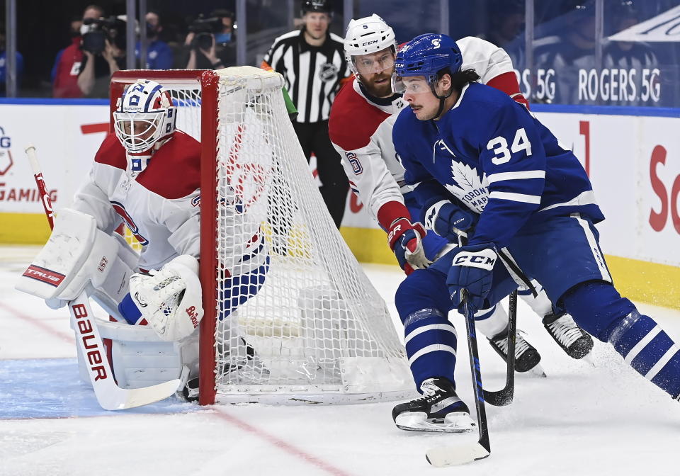 FILE - In this April 7, 2021, file photo, Toronto Maple Leafs forward Auston Matthews (34) scores on a wraparound past Montreal Canadiens goaltender Jake Allen (34) as Canadiens defenseman Shea Weber (6) pursues during the first period of an NHL hockey game in Toronto. The rear-view mirror is something Toronto stars Matthews and Mitch Marner are doing their best to ignore as the NHL season approaches. (Nathan Denette/The Canadian Press via AP, File)