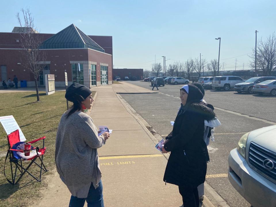 Sam Luqman (left) speaks to voters outside Salina Intermediate School on primary election day on Feb. 27, 2024. She was asking voters to vote "uncommitted" on the Republican primary ballot as a protest against President Joe Biden's support for Israel.