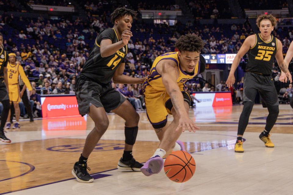 Mar 9, 2024; Baton Rouge, Louisiana, USA; LSU Tigers forward Jalen Reed (13) looses the ball on a dribble against Missouri Tigers guard Anthony Robinson II (14) during the first half at Pete Maravich Assembly Center. Mandatory Credit: Stephen Lew-USA TODAY Sports