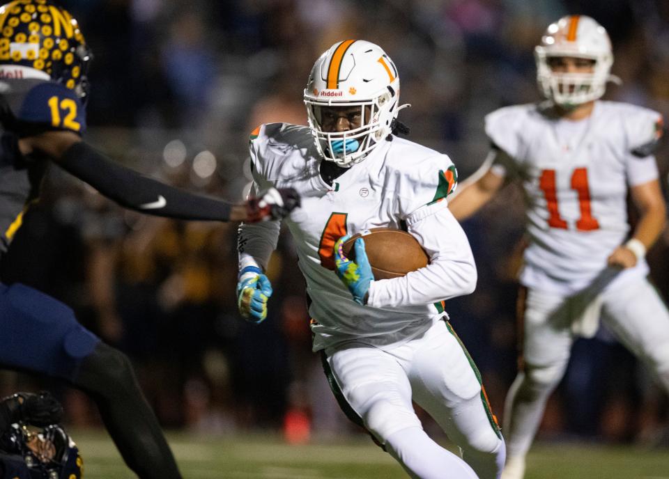 Dunbar Tigers receiver T.J. Abrams (4) runs the ball outside during the third quarter of the Class 3S regional championship against the Naples Golden Eagles at Staver Field in Naples on Friday, Nov. 24, 2023.