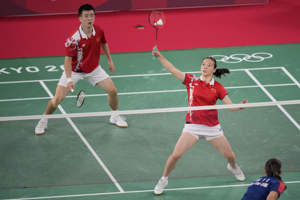 China's Zheng Si Wei, left, and Huang Ya Qiong play against Hong Kong's Tang Chun Man and Tse Ying Suet during their mixed doubles semifinal matchat the 2020 Summer Olympics, Thursday, July 29, 2021, in Tokyo, Japan. (AP Photo/Dita Alangkara)