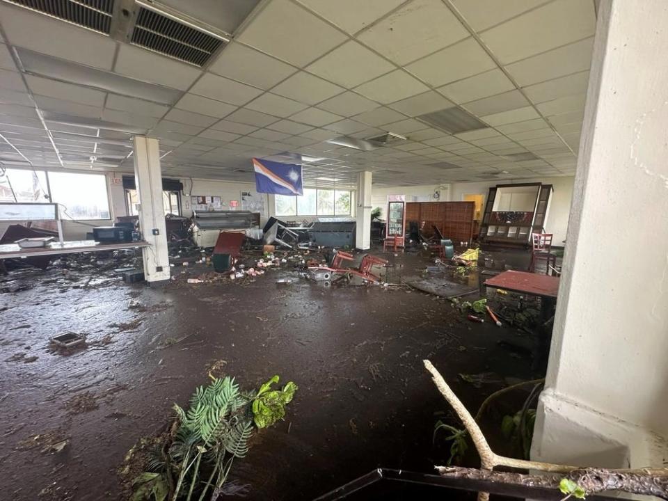 debris is scattered amid water inside a cafe
