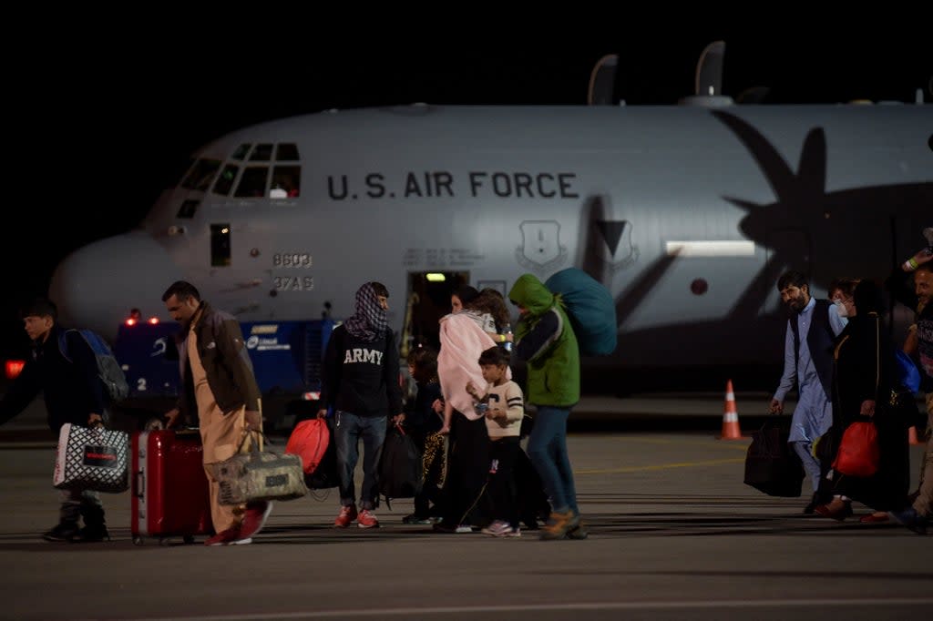 Some refugees boarding planes reportedly do not know where they are heading (AFP via Getty)