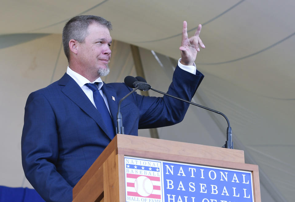 National Baseball Hall of Fame inductee Chipper Jones peaks during an induction ceremony at the Clark Sports Center on Sunday, July 29, 2018, in Cooperstown, N.Y. (AP Photo/Hans Pennink)