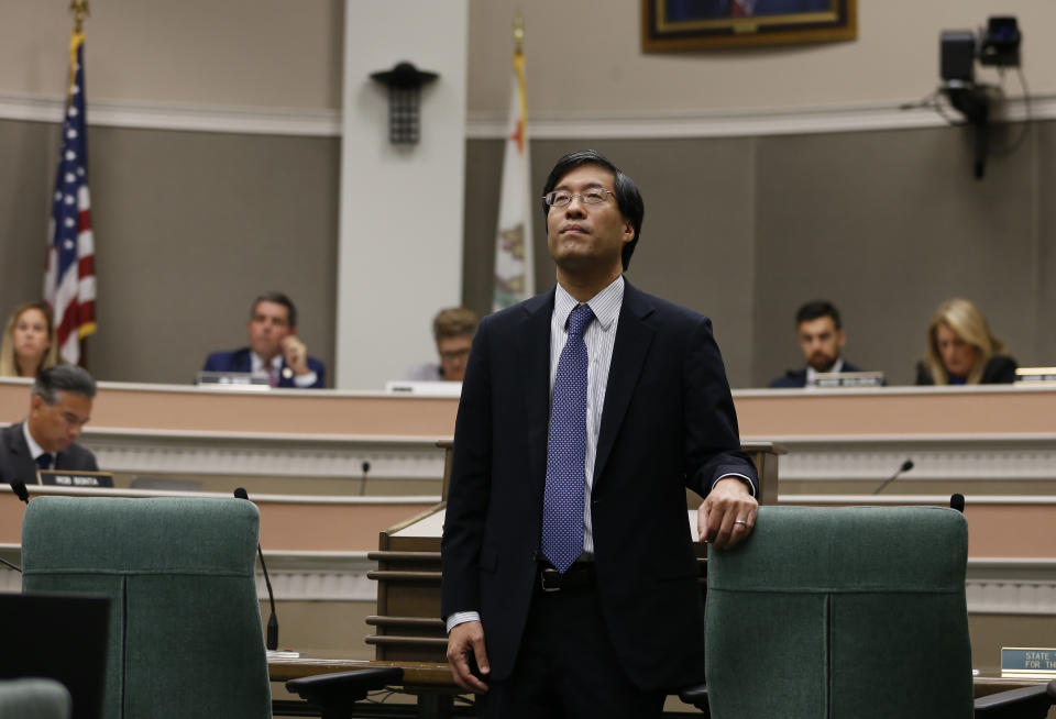 State Sen. Richard Pan, D-Sacramento, a pediatrician, listens as members of the public called on lawmakers to reject his measure that would give public health officials oversight of doctors that may be giving fraudulent medical expeditions from vaccinations during a hearing of the Assembly Health Committee at the Capitol in Sacramento, Calif., Thursday, June 20, 2019. (AP Photo/Rich Pedroncelli)