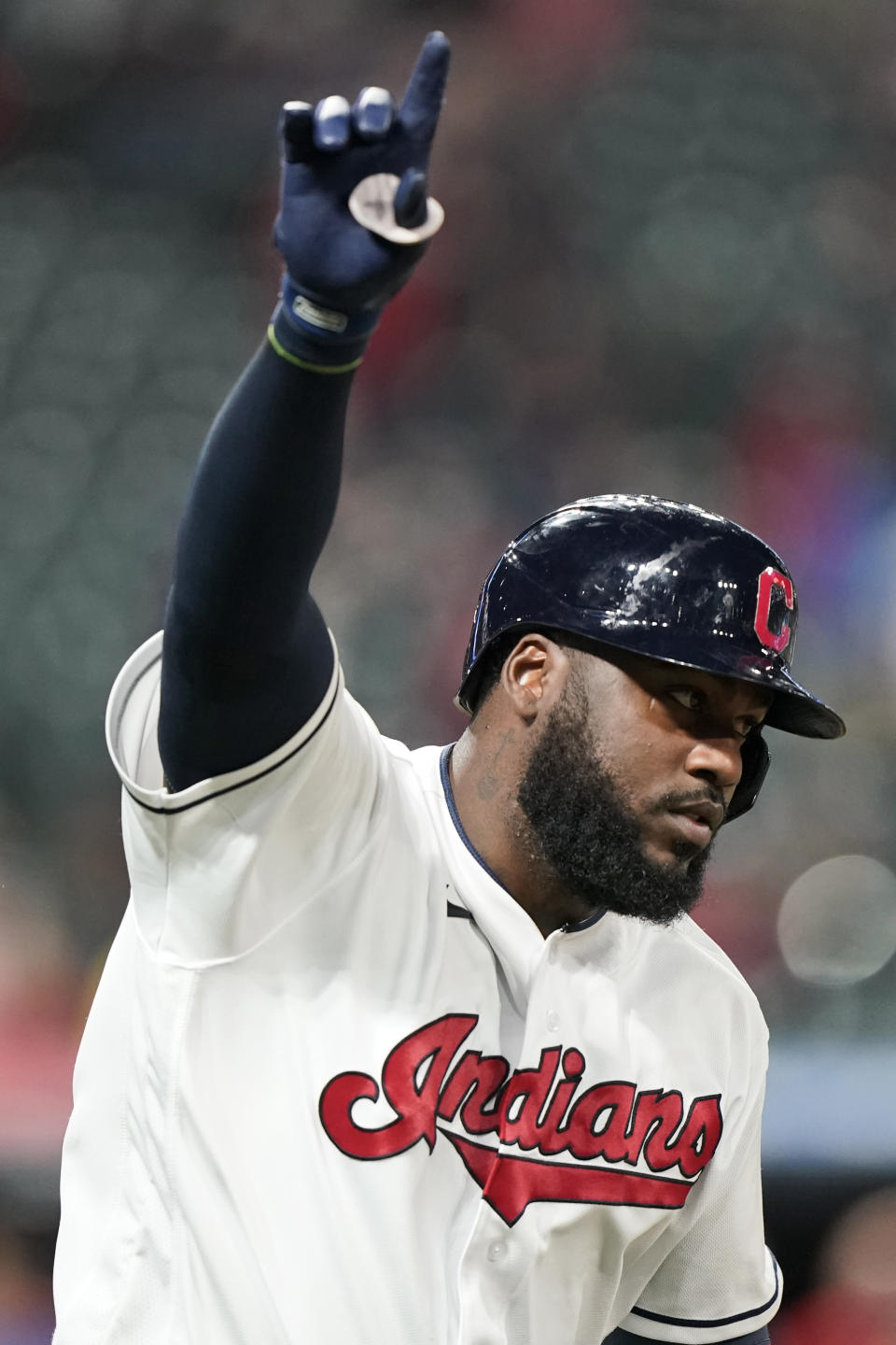 Cleveland Indians' Franmil Reyes points as he runs the bases after hitting a solo home run during the sixth inning of the team's baseball game against the Detroit Tigers, Friday, April 9, 2021, in Cleveland. (AP Photo/Tony Dejak)