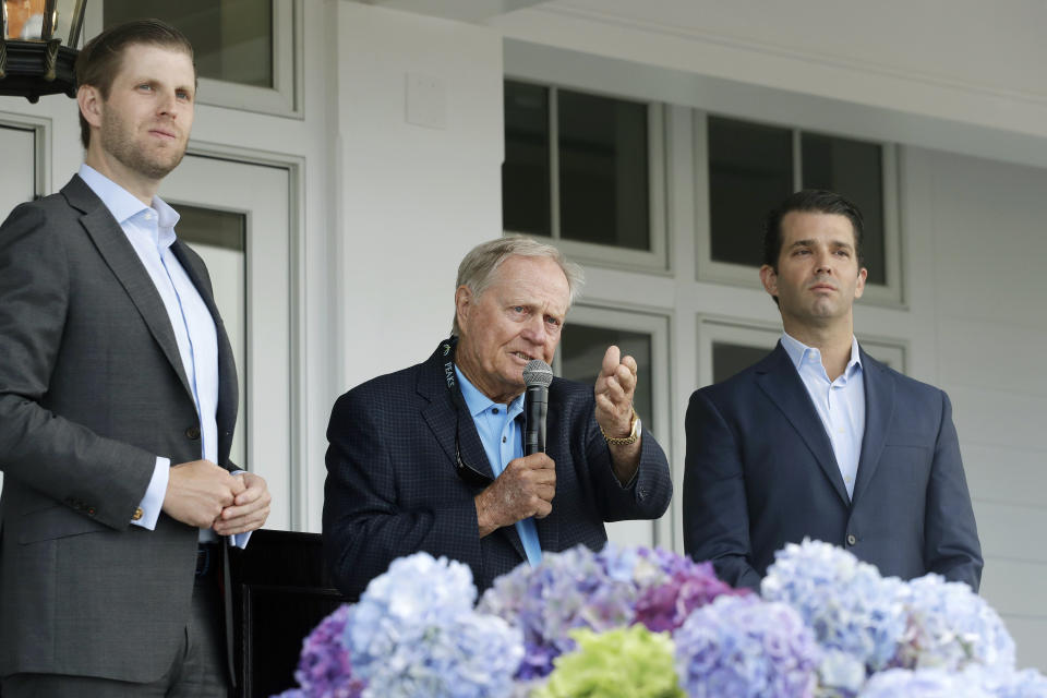 In this June 11, 2018 photo, Eric Trump, left, Jack Nicklaus, center, and Donald Trump Jr. attend the opening of the Trump Golf Links clubhouse in the Bronx borough of New York. President Donald Trump's company posted annual losses at his golf course in the Bronx for the first time since it opened four years ago as expenses rose, greens fees barely budged and the opening of a clubhouse was delayed. (AP Photo/Mark Lennihan)