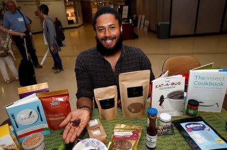 Anthony Hatinger, co-founder of Detroit Ento, a start-up turning locally sourced insects into food products, holds freeze-dried edible crickets in his hand during the 'Eating Insects Detroit: Exploring the Culture of Insects as Food and Feed' conference at Wayne State University in Detroit, Michigan May 26, 2016. REUTERS/Rebecca Cook