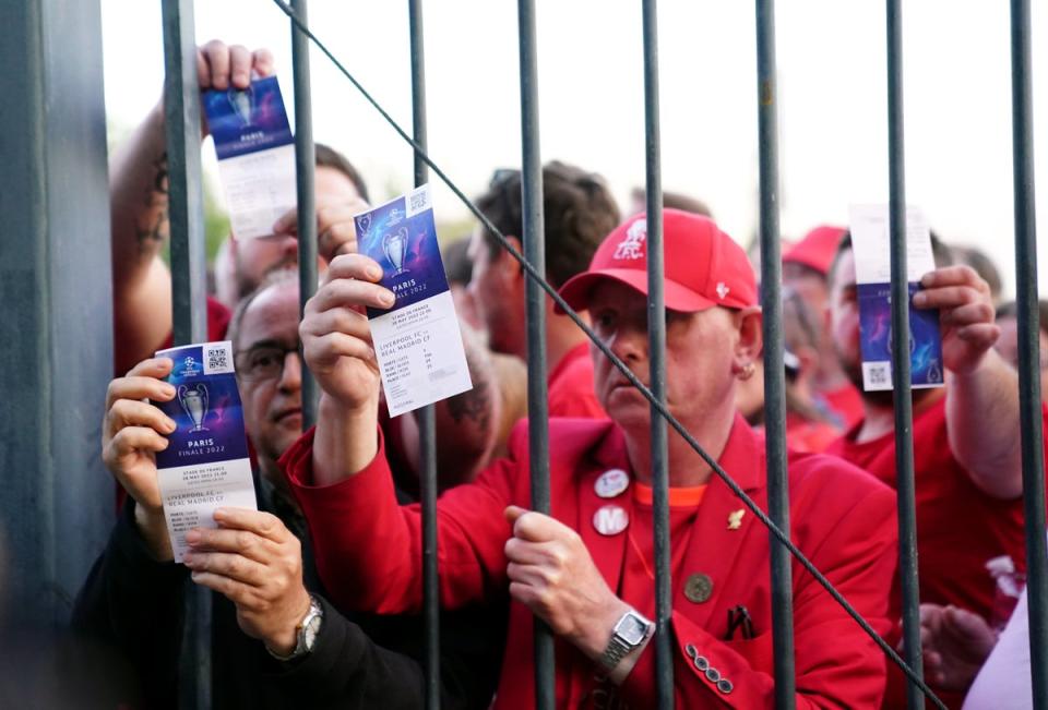 Liverpool fans stuck outside the ground show their match tickets (Adam Davy/PA) (PA Wire)